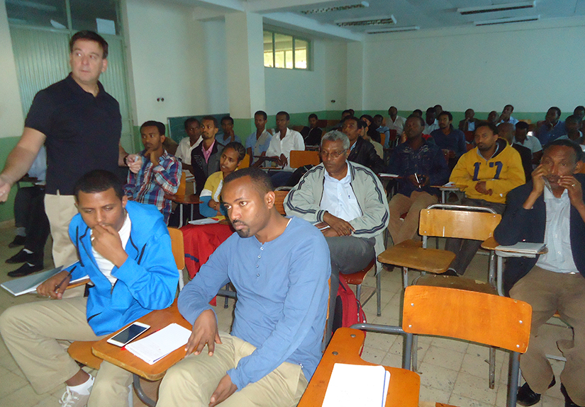 Michael Bisesi, PhD, left, a co-lead for GOHi and the senior associate dean of academic affairs at the College of Public Health, gives a presentation in Ethiopia in 2013. (Photo credit: Rick Harrison)