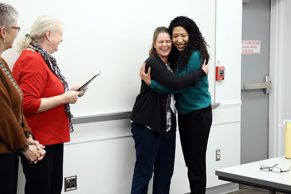 Alison Norris and Parvati Singh hug