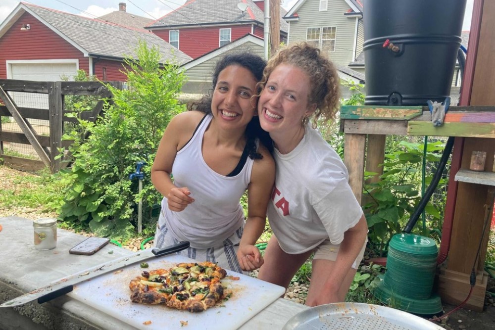 two students with healthy food at Franklinton Farms