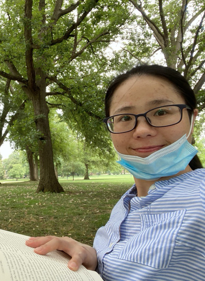 Li Li standing in open wooded area