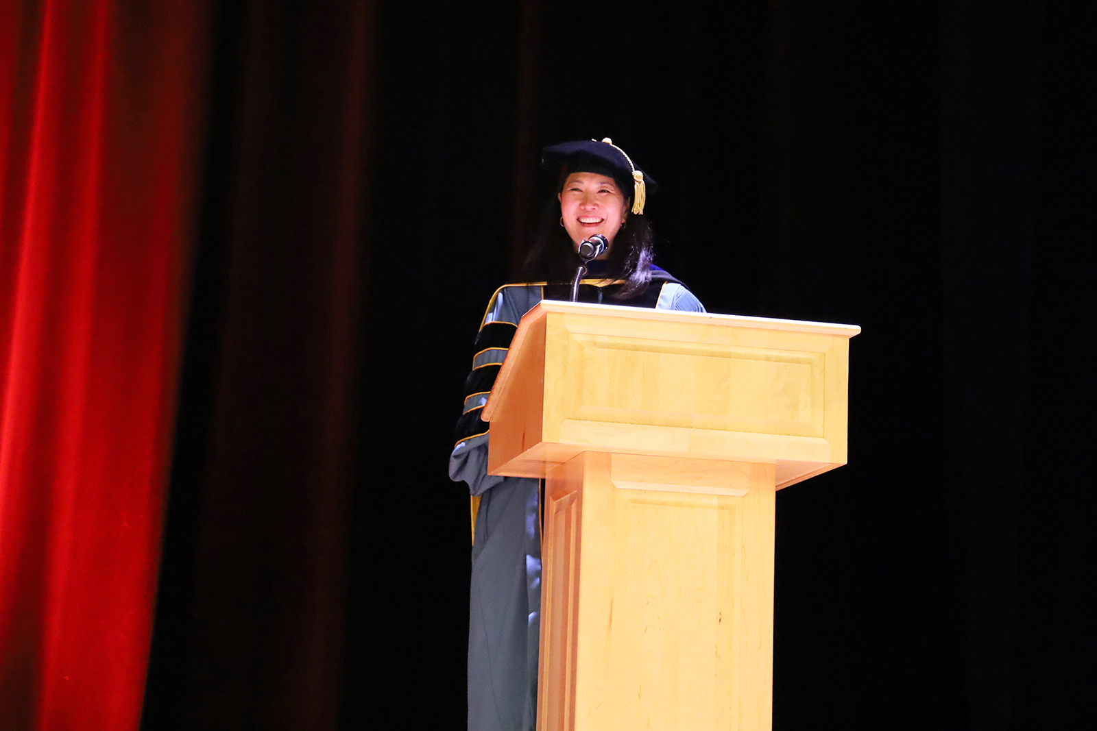 Paula Song stands at a lecturn.