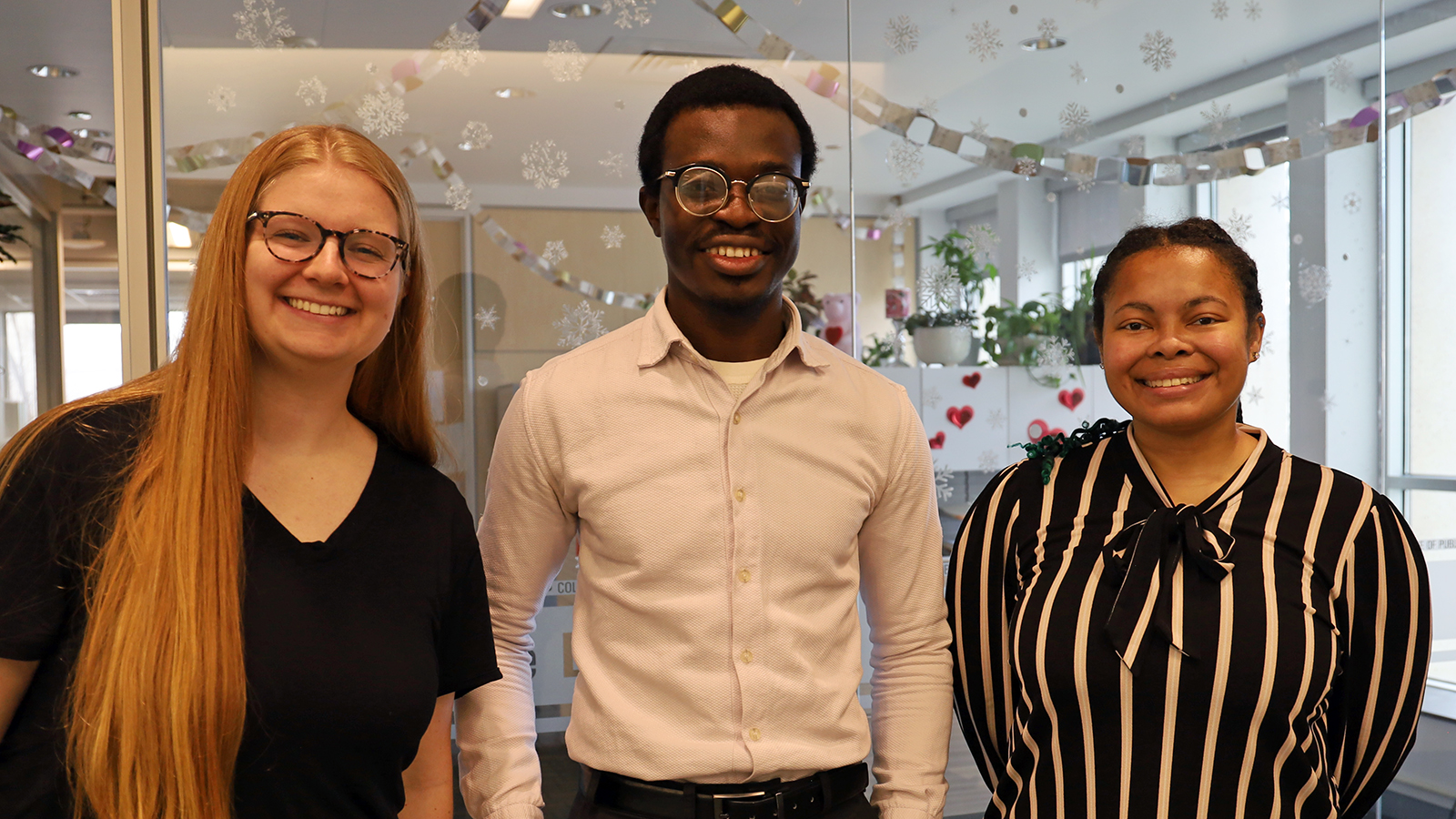 three people pose for a photo