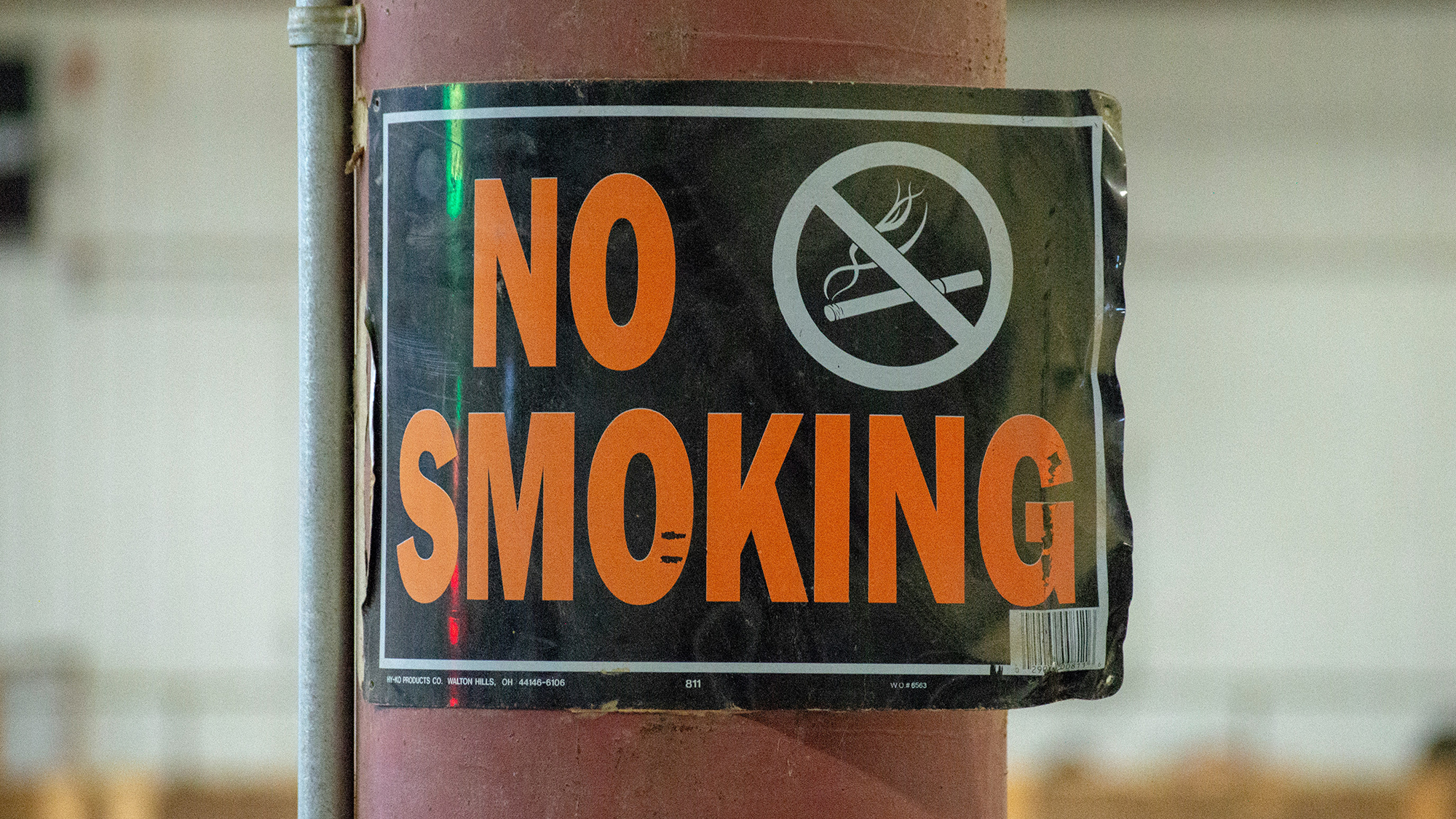 A "no smoking" sign affixed to a pole.