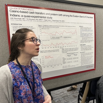 Julie Strominger in front of their poster