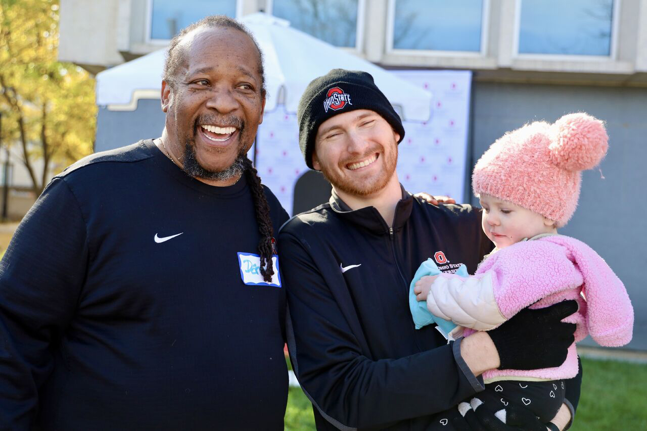 Darryl Hood and Robert Hood, who is holding a small child dressed in pink