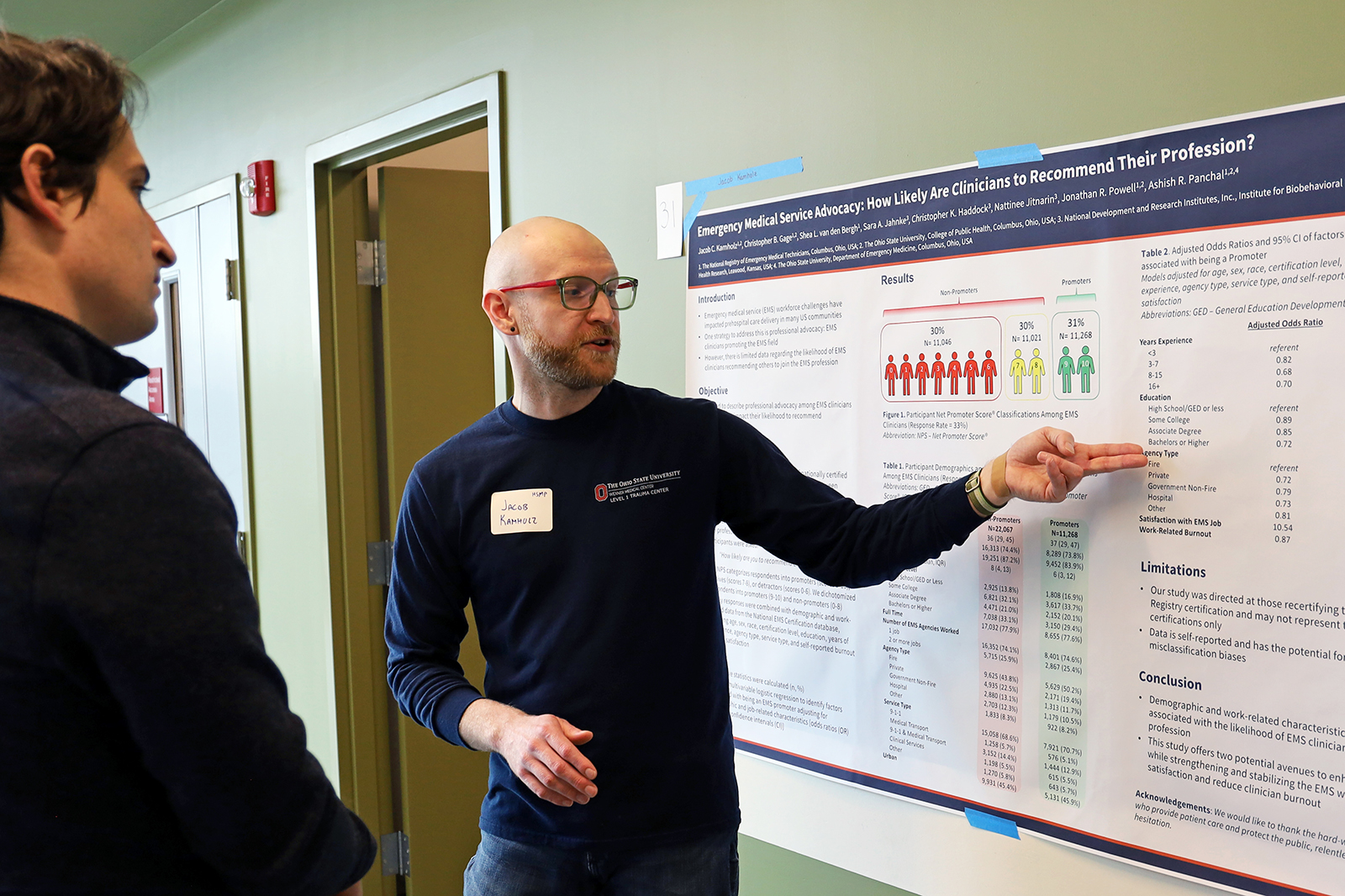 Jacob Kamholz points to his research poster