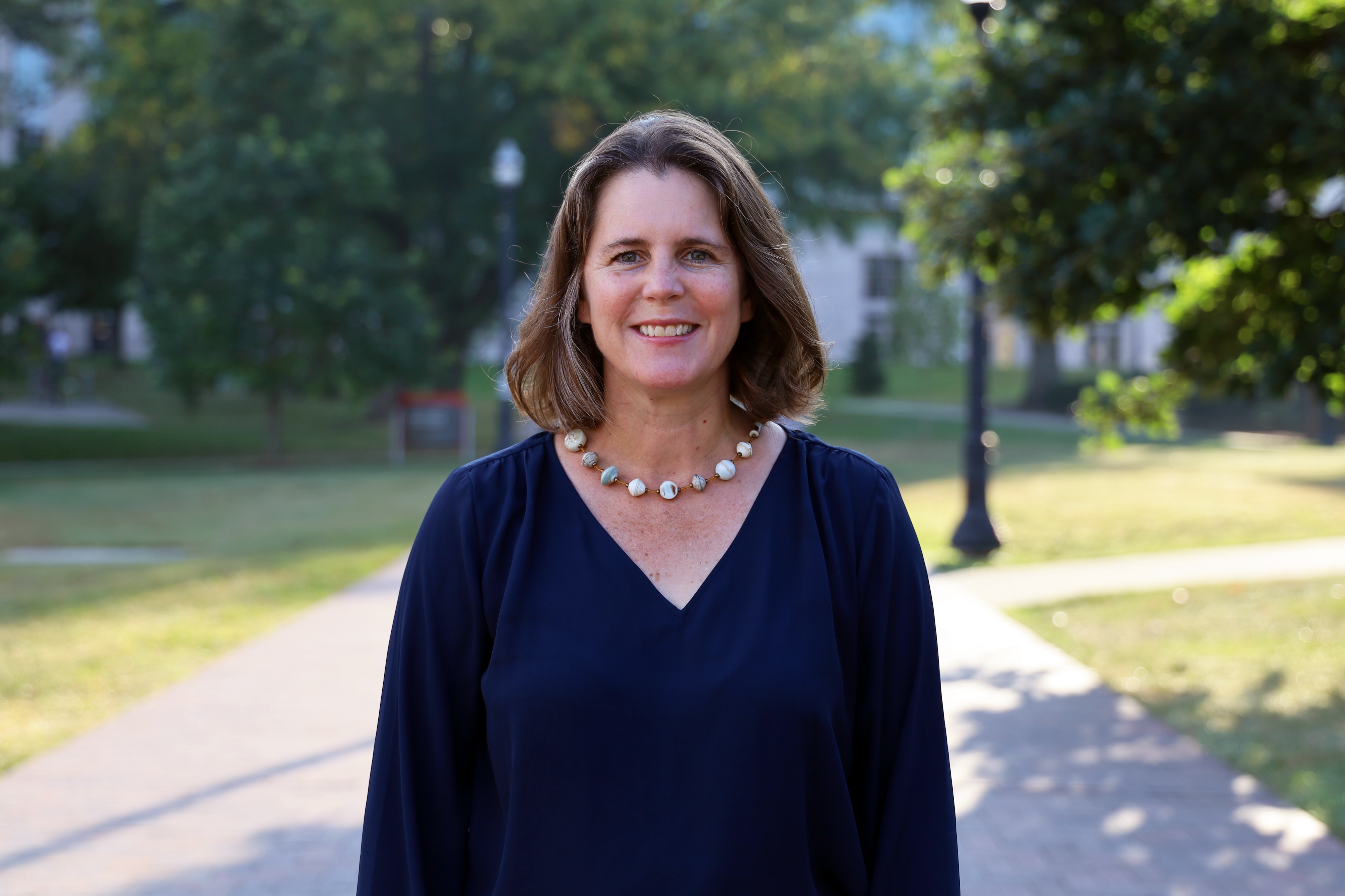 Alison Norris stands outside on campus