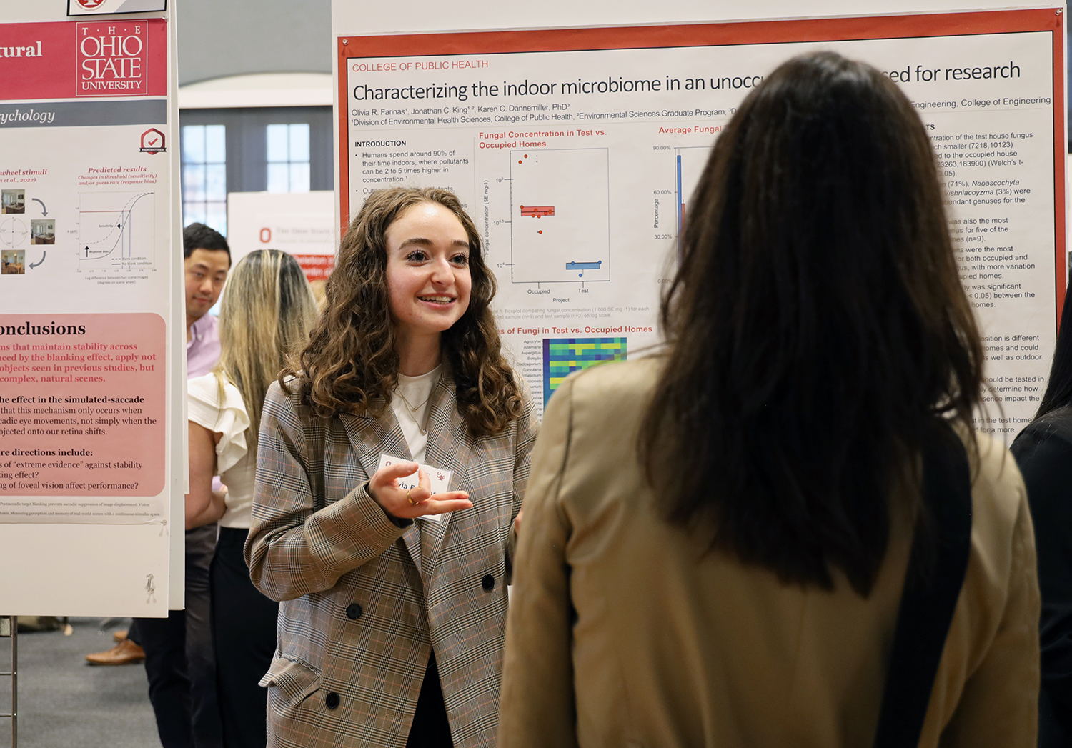 Olivia Farinas speaks to a Denman Undergraduate Research Forum attendee on March 5, 2024.