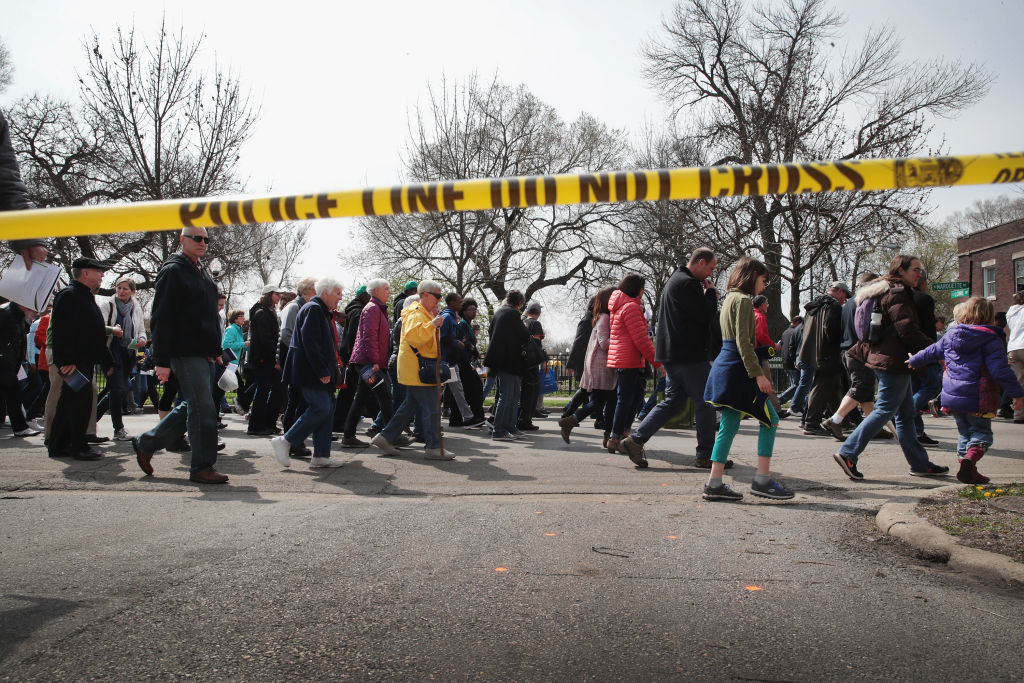 CHICAGO, IL - APRIL 14: Marchers, led by Cardinal Blase Cupich, walk through the Englewood neighborhood calling for an end to the violence that has plagued the city on April 14, 2017 in Chicago, Illinois. The marchers stopped several times to reflect on the Stations of the Cross and to read out the names of Chicago homicide victims. With 14 homicides so far in 2017, Englewood is one of the most violent neighborhoods in the city. (Photo by Scott Olson/Getty Images)