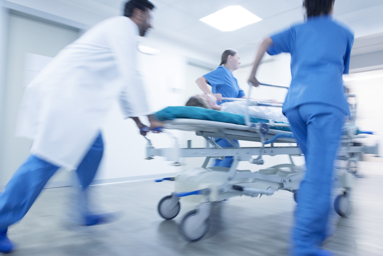 Medical team rushing into hospital with patient on a stretcher