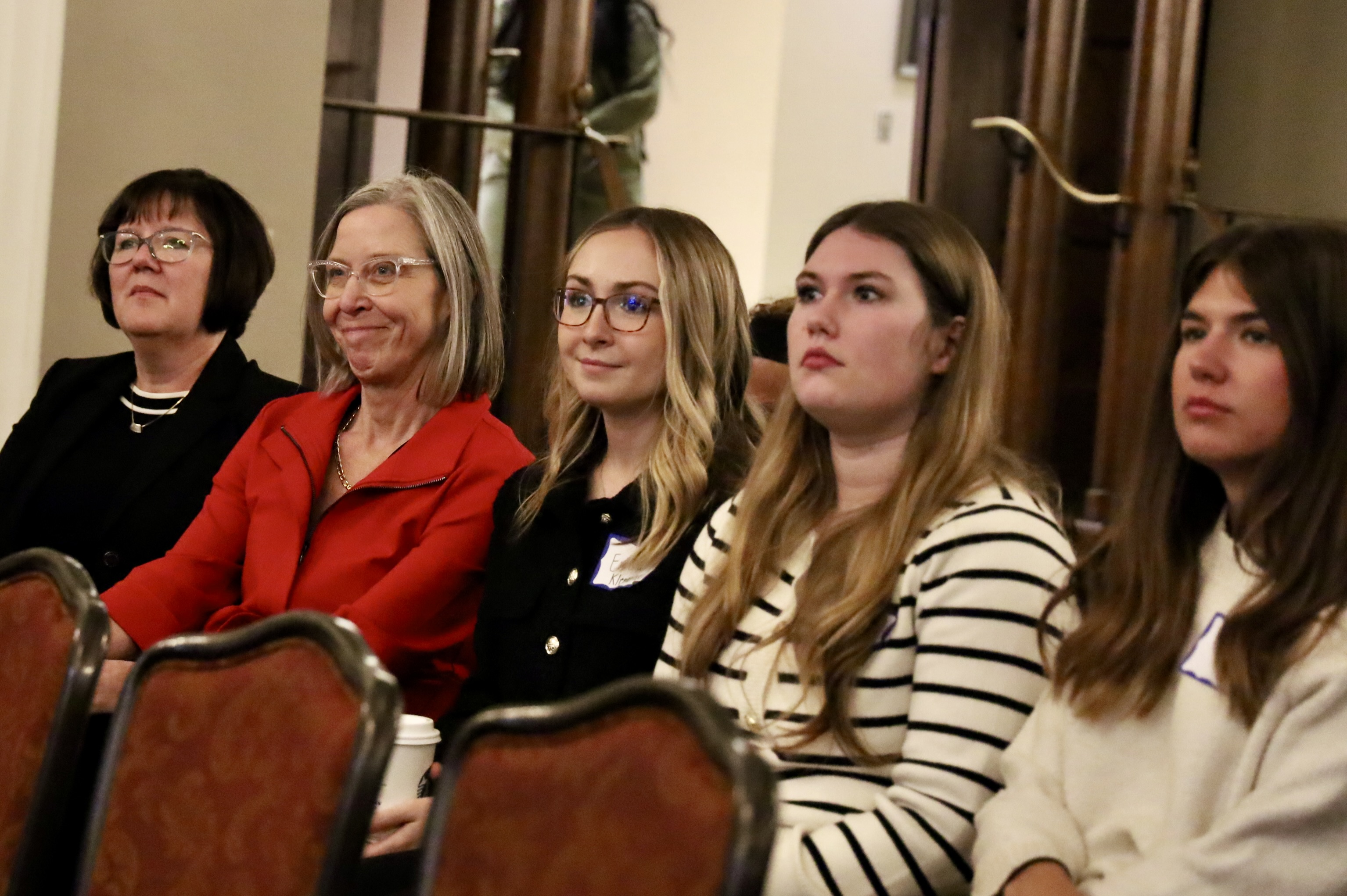 Audience members look on