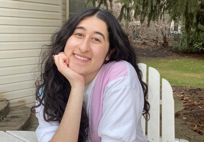 Monica sitting outside smiling