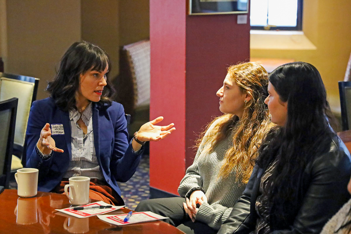 Two students networking with a CPH alumnae