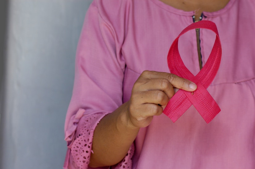 woman holding cancer ribbon