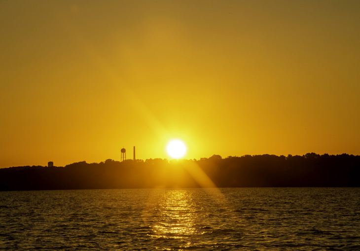 sun setting over city