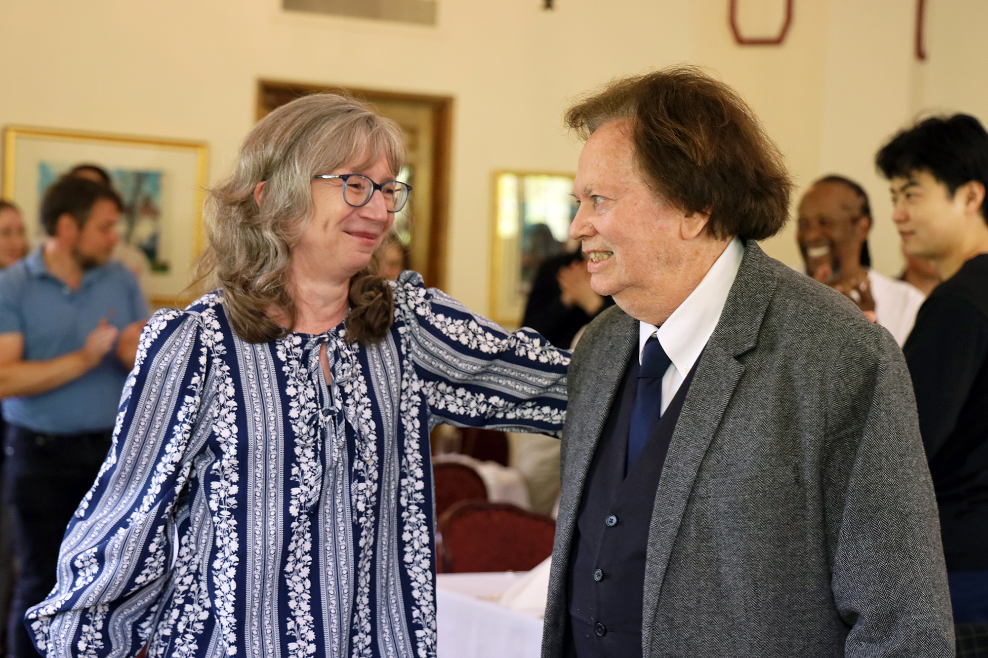 Amy Ferketich and Randall Harris smile at one another.