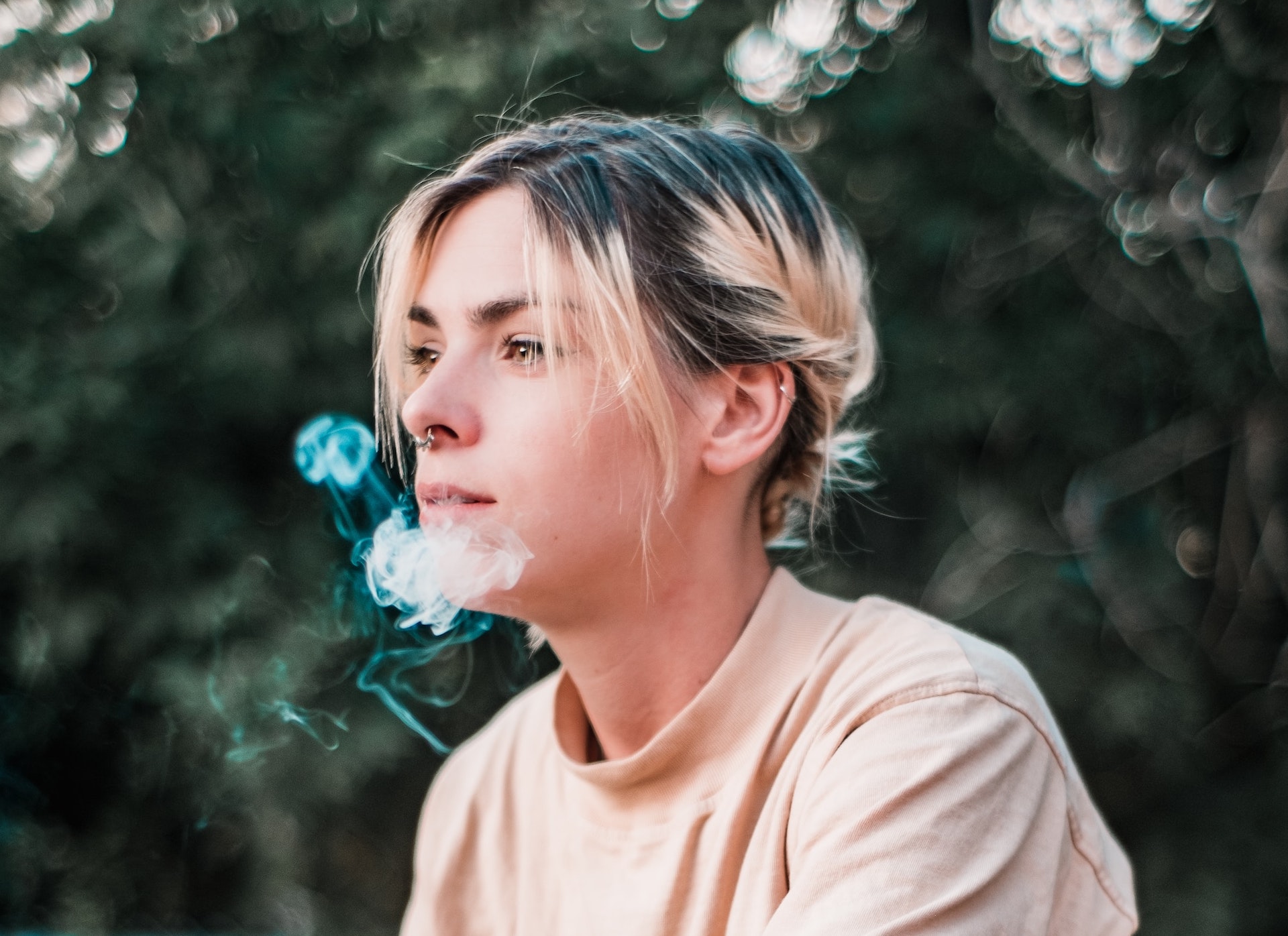 young woman with e-cigarette smoke