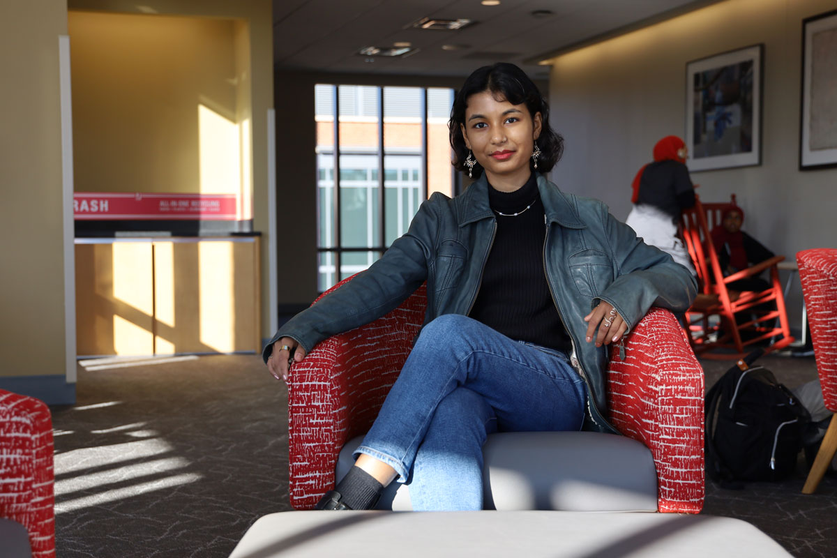 Oshin Samuel sitting in a chair located in a sun-lit study room of the Ohio Union