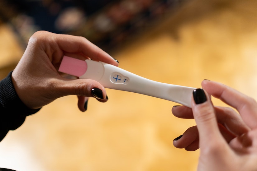 woman holding pregnancy test