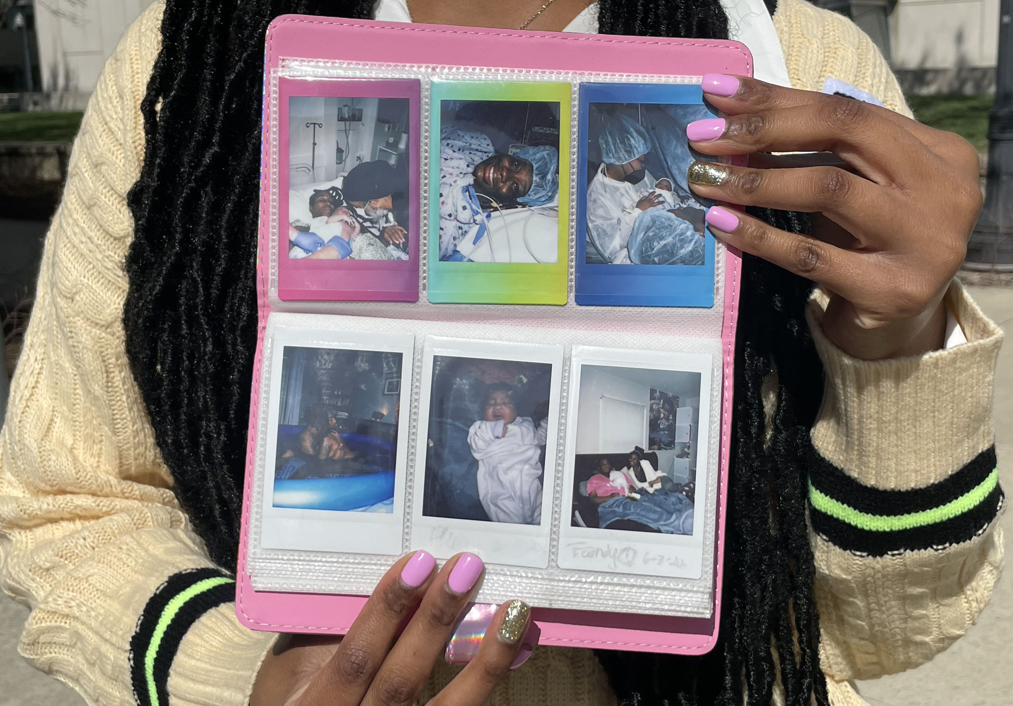 Summernickol Stewart holds a book of photos from her doula work