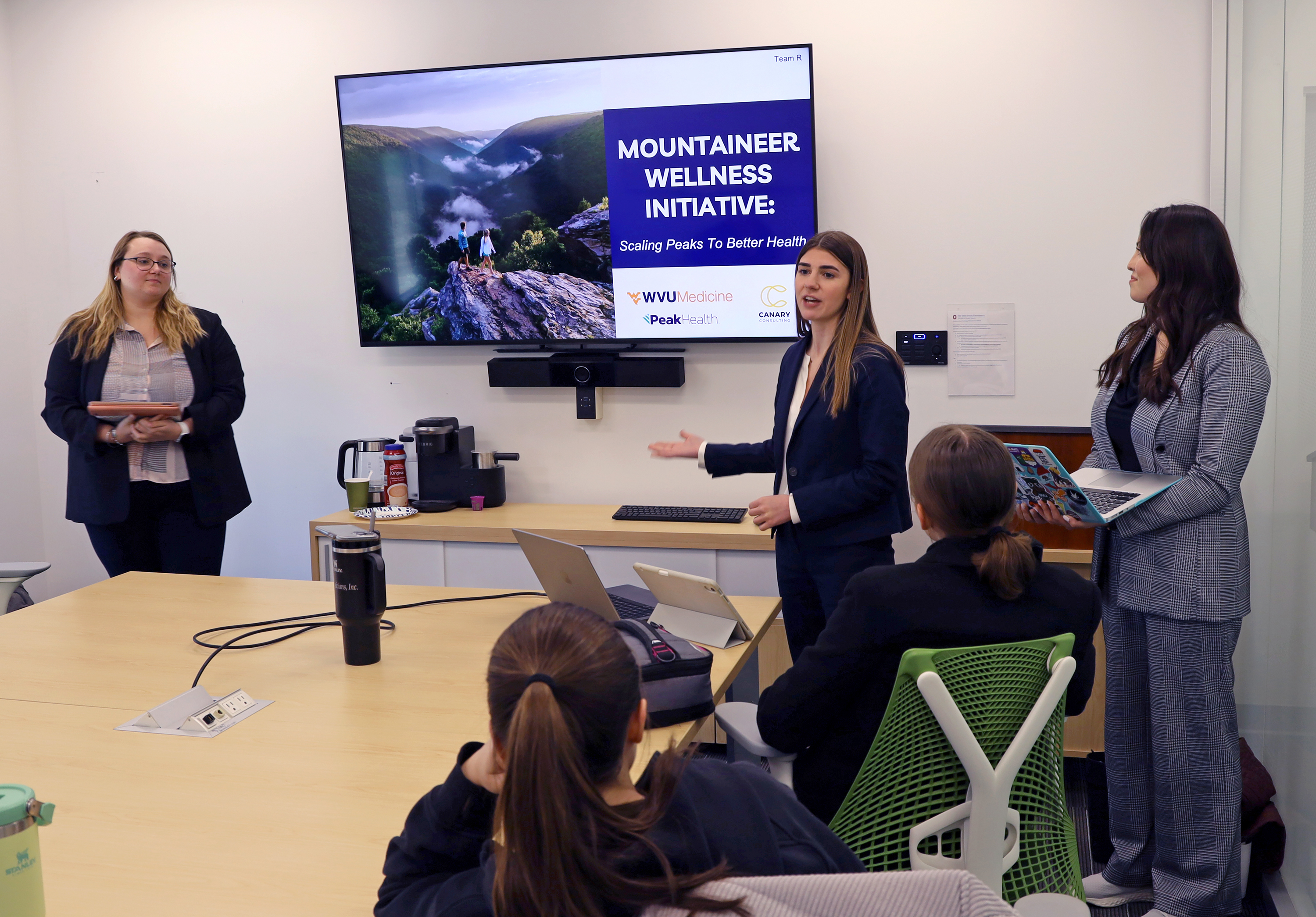 MHA students give a presentation to their classmates.