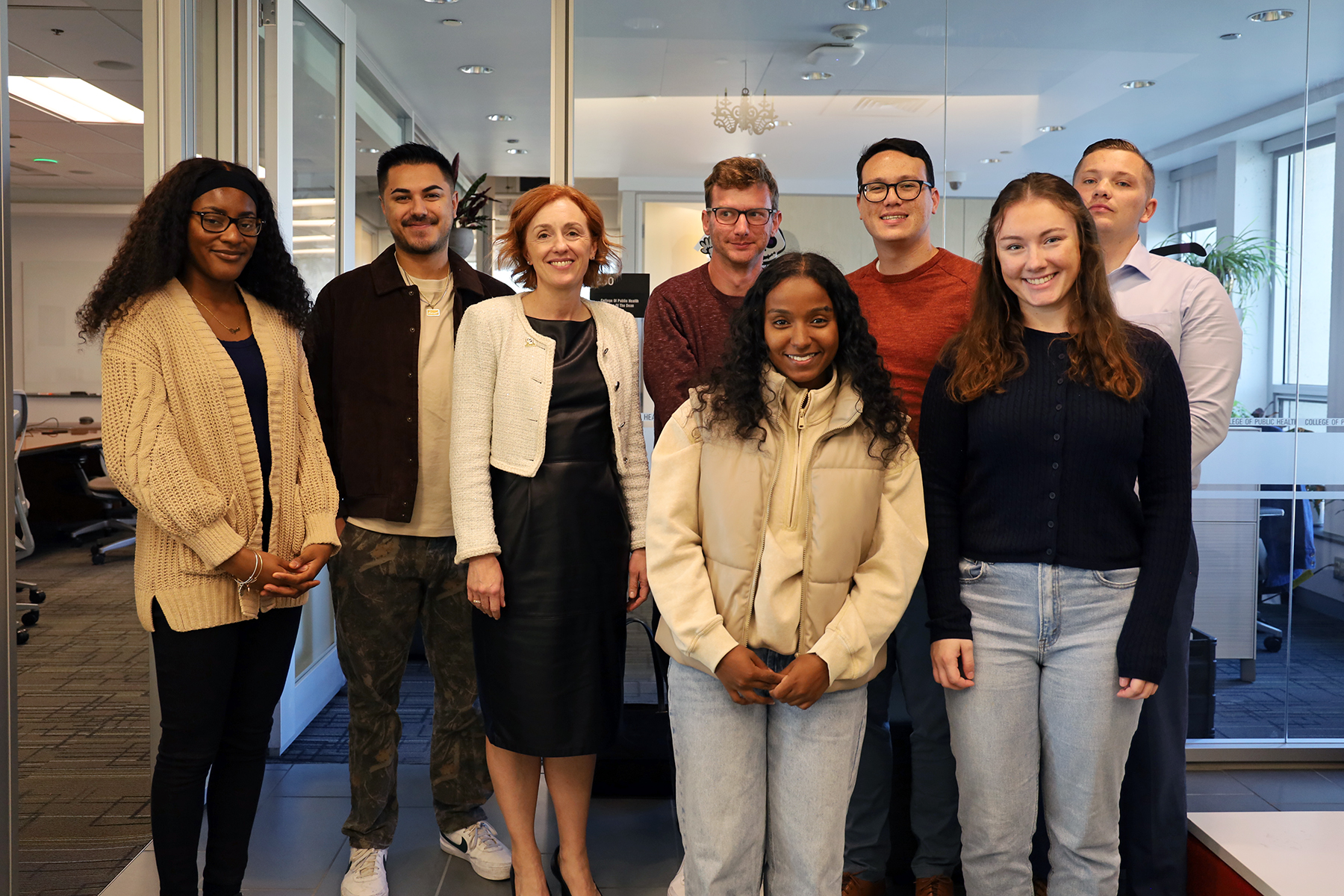 Emmy Betz poses for a photo with public health students in Cunz Hall.