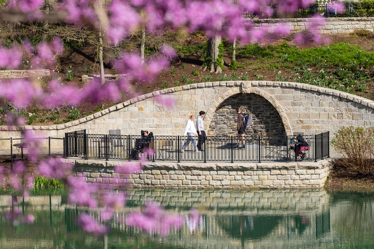 Students walk along Mirror Lake on Ohio State's Columbus campus