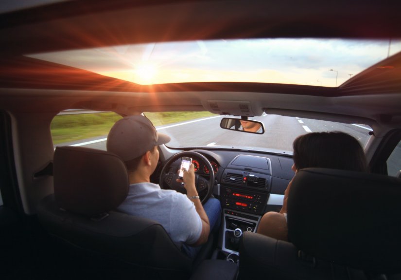person texting while driving