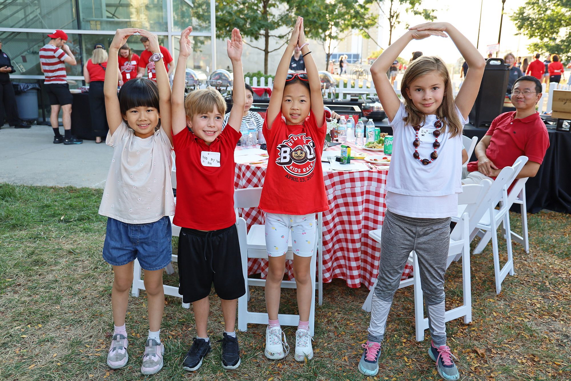 Children spell out O-H-I-O with their arms