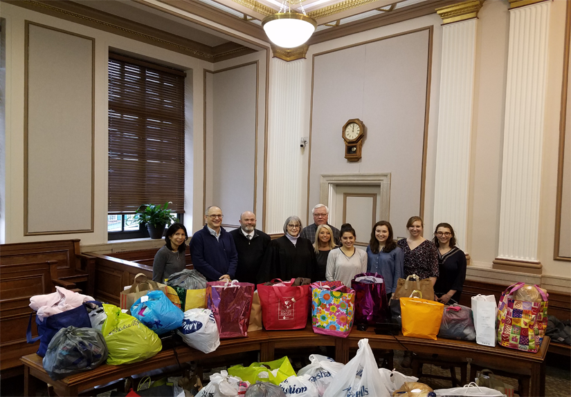 Members of the Public Health Student Leadership Council deliver warm clothing to the Scioto County courthouse. The donations went to families affected by the opioid crisis.