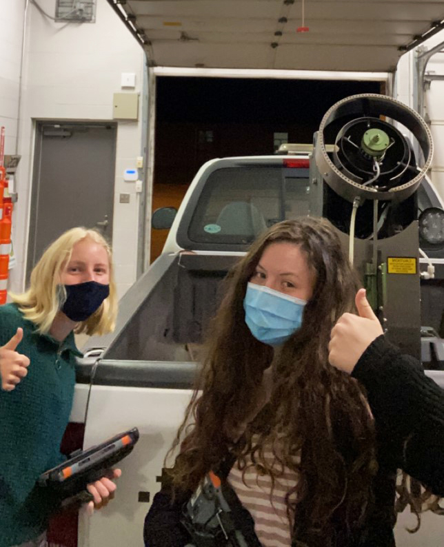 Amelia Soergel, right, and fellow Richland Public Health intern in front of a mosquito fogger