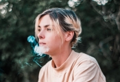 young woman with e-cigarette smoke