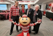 Aram Dobalian, Amy Fairchild and two attendees pose with Brutus for a photo at the Cleverly at 10 event.