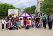 Members of the CPH community pose with a playhouse they built on April 17, 2024.