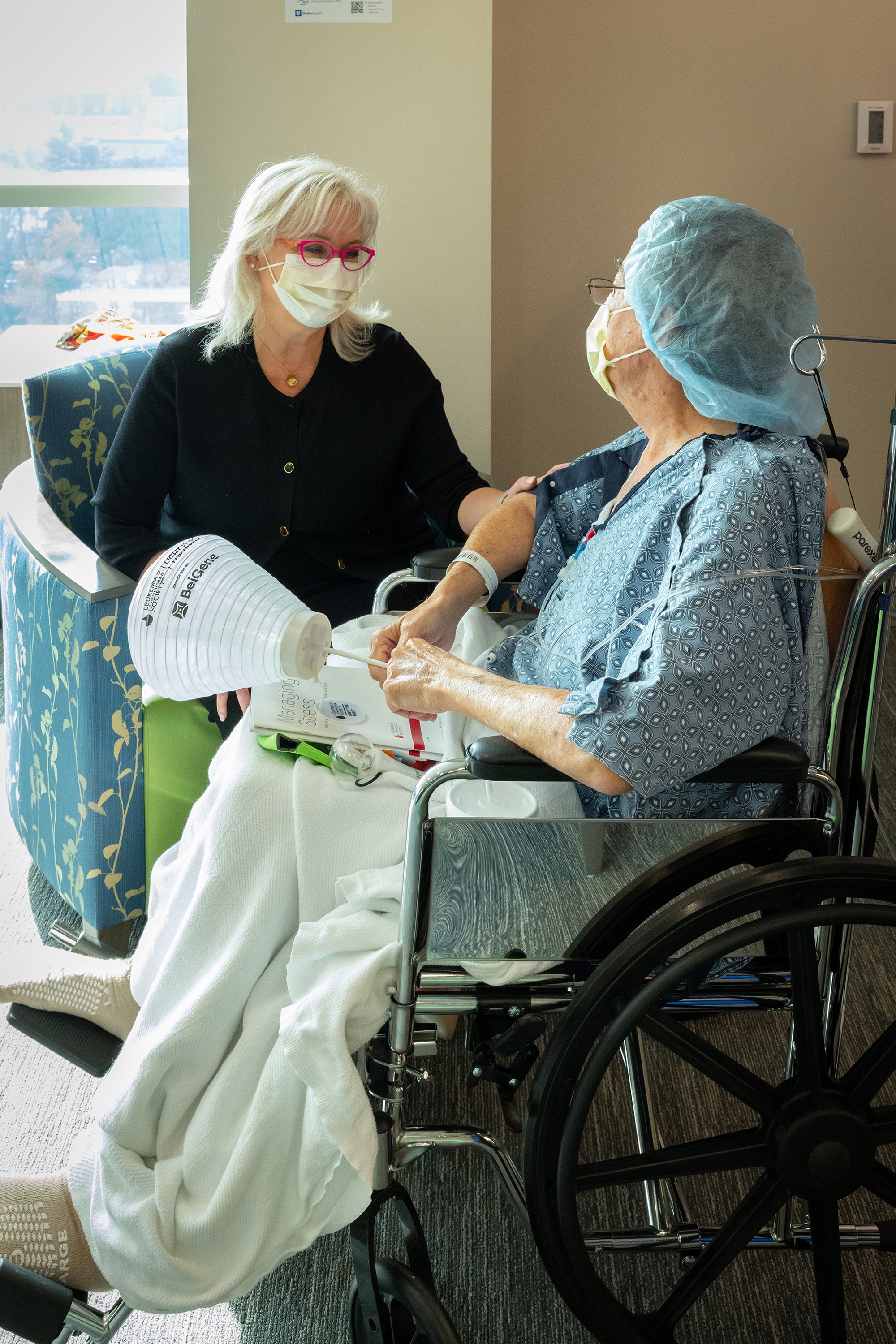 Peyton Howell sits with a patient in the hospital