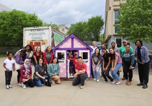 Members of the CPH community pose with a playhouse they built on April 17, 2024.