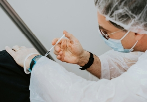 A health care provider administers a vaccine.