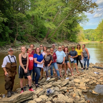 Jason Marion and a group of students pose for a photo at Silver Creek in Madison County, Kentucky.