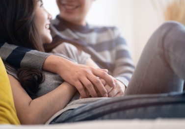 Couple on couch hugging