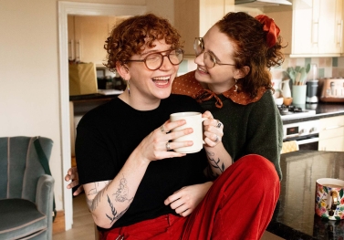 Queer couple laughing