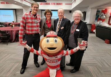 Cleverly at 10 attendees smile for a photo with Brutus