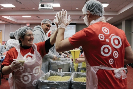 volunteers preparing meals with high 5