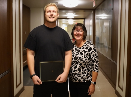 Jonathan Schmidt with Kelly Scheiderer holding his award