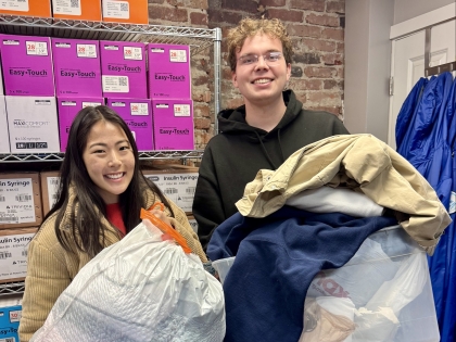 Students holding clothing drive donations