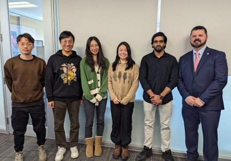 Students who competed in the Three Minute Thesis competition pose for a photo