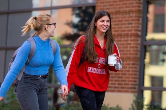 students walking and smiling on campus