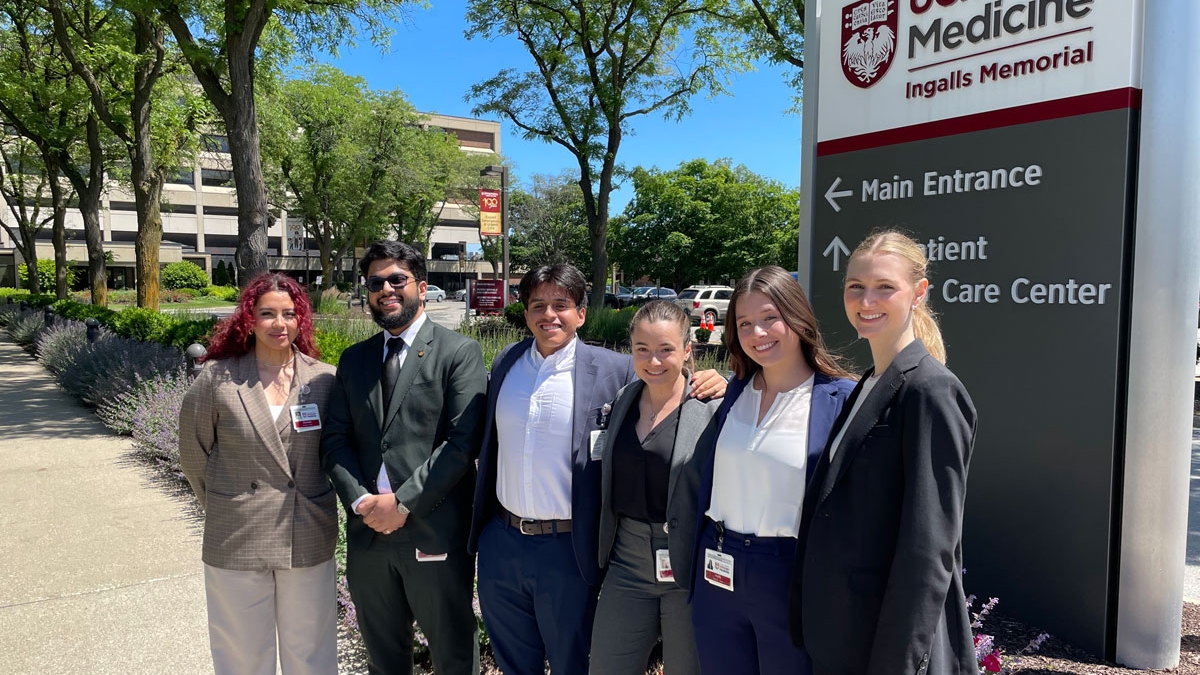 Administrative residency students stand in front of the UChicago Medicine sign