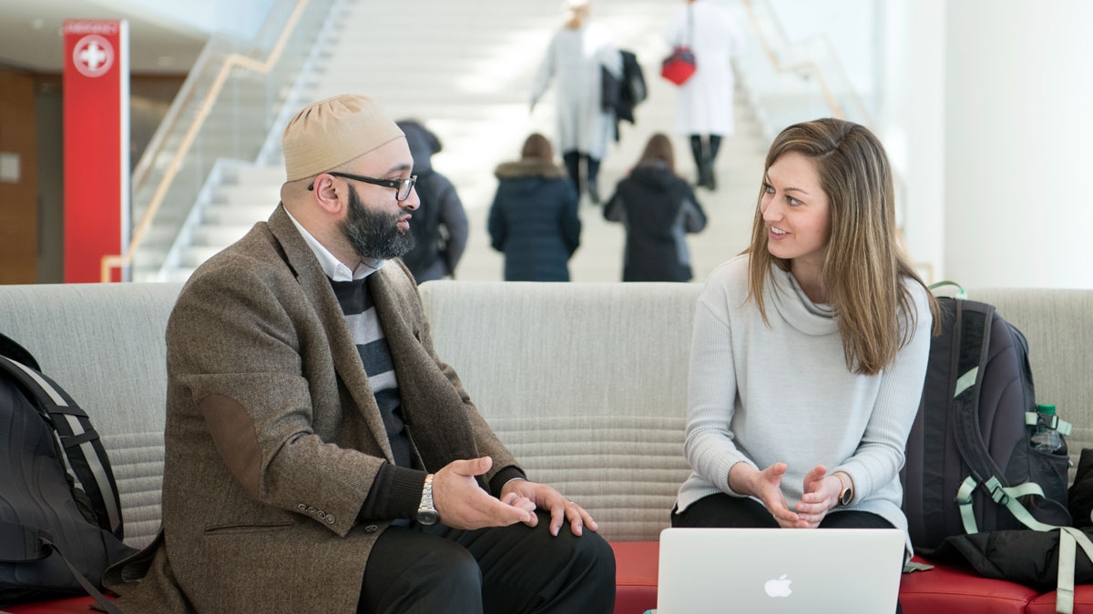 Professor and student chat in a building on Ohio State's campus