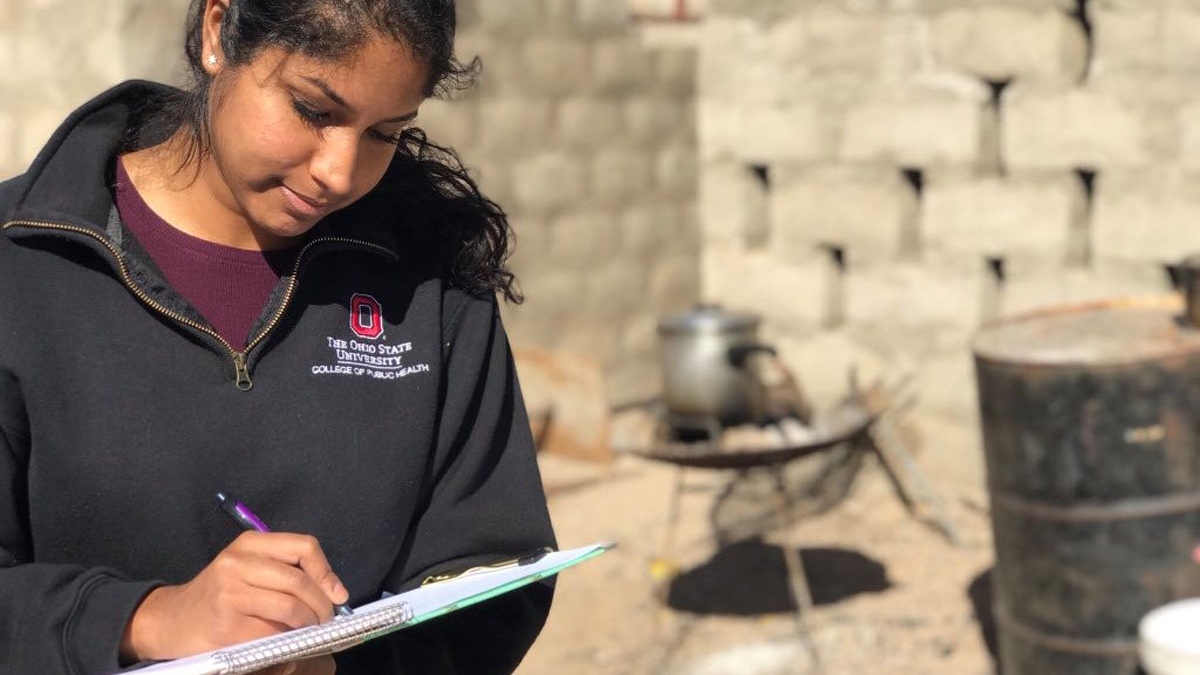 Woman records research data during an education abroad experience