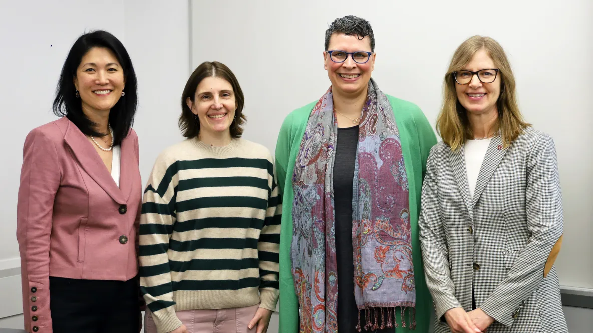 Four people pose in a row on March 9.